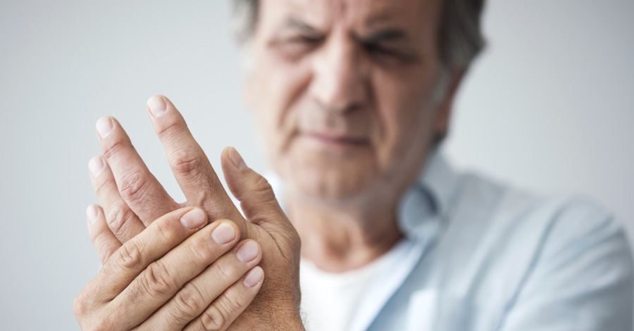 Man with joint pain in his fingers from arthritis
